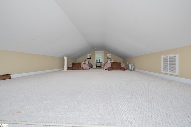 bonus room with carpet floors and vaulted ceiling