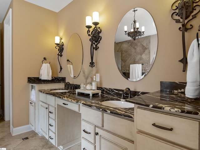 bathroom with tile patterned flooring, vanity, and an inviting chandelier