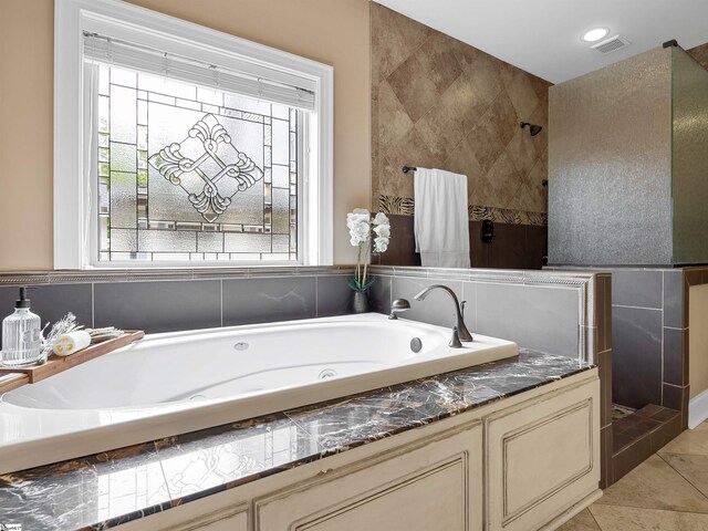 bathroom featuring tile patterned flooring and plus walk in shower