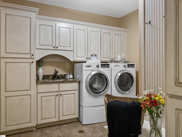 washroom featuring cabinets, independent washer and dryer, sink, and light tile patterned floors