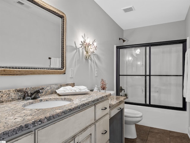 full bathroom featuring tile patterned floors, vanity, toilet, and shower / bath combination with glass door