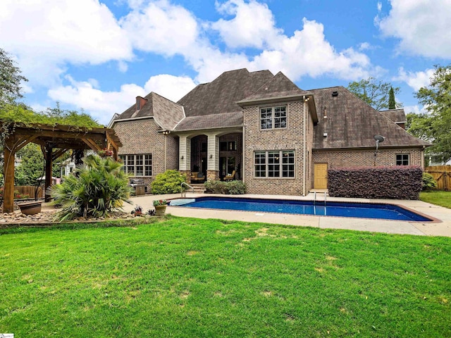 rear view of house featuring a pergola, a yard, and a patio