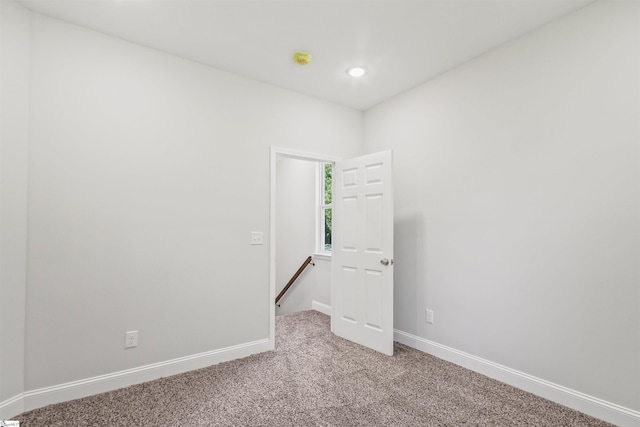 unfurnished room with recessed lighting, baseboards, and carpet floors