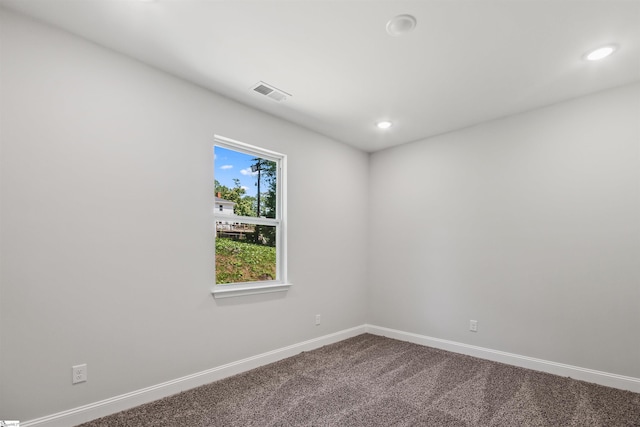empty room featuring recessed lighting, baseboards, visible vents, and dark carpet