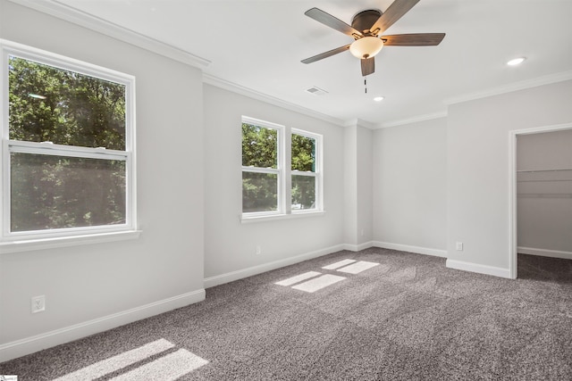 carpeted spare room with ceiling fan and crown molding