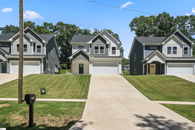 traditional-style home with an attached garage, a front yard, driveway, and board and batten siding