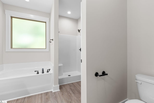 bathroom with plus walk in shower, wood-type flooring, and toilet