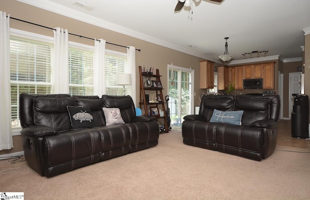 carpeted living room featuring ceiling fan and ornamental molding