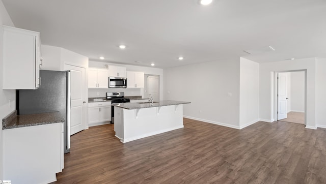 kitchen featuring sink, white cabinetry, a center island with sink, dark hardwood / wood-style flooring, and stainless steel appliances