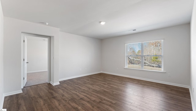 empty room featuring dark hardwood / wood-style floors