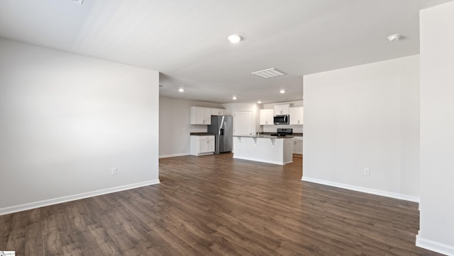 unfurnished living room featuring dark wood-type flooring