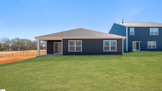 rear view of house with a lawn