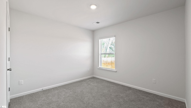 unfurnished room featuring carpet