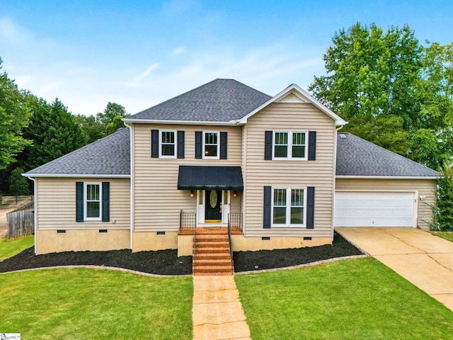 front facade with a garage and a front lawn