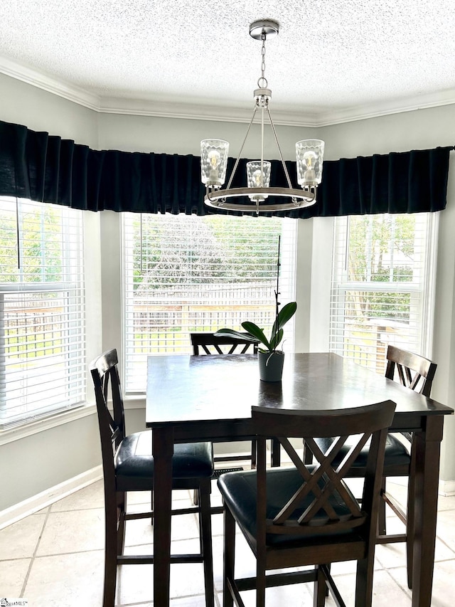 dining area with tile patterned flooring, crown molding, and a chandelier