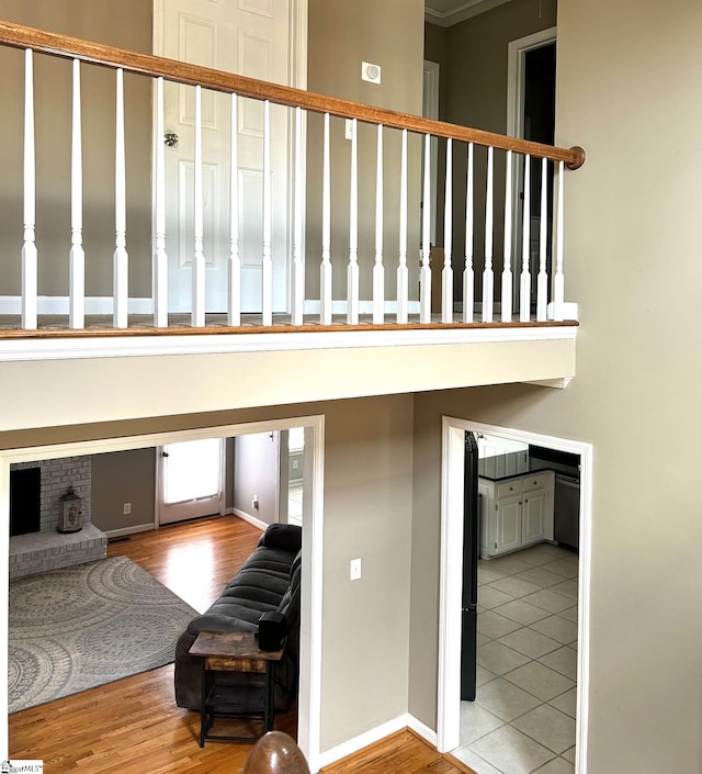 staircase featuring a fireplace and tile patterned floors