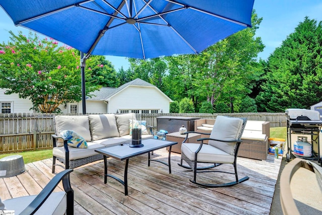 deck featuring outdoor lounge area and a grill