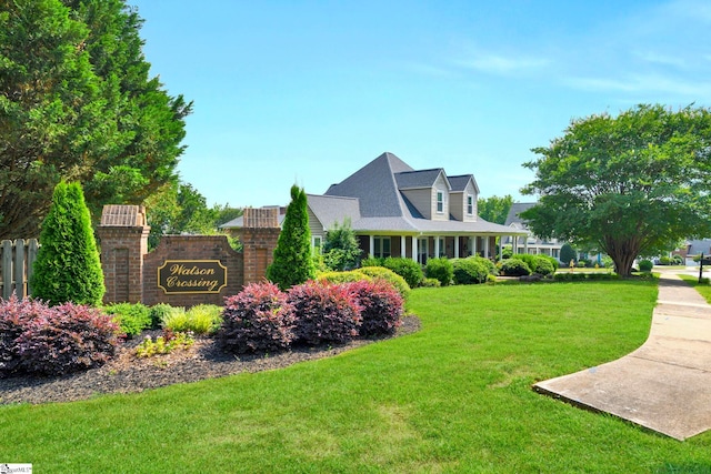 community sign featuring a lawn