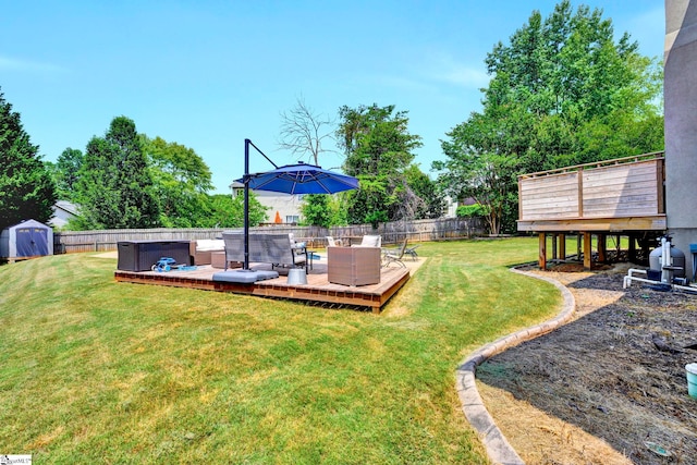 view of yard featuring an outdoor living space, a storage shed, and a wooden deck