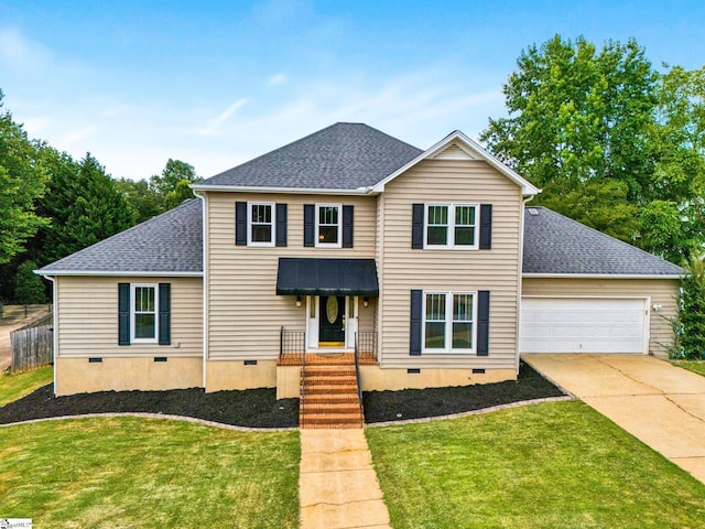 front of property featuring a front yard and a garage