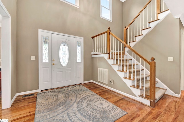 entrance foyer with light hardwood / wood-style floors and a high ceiling