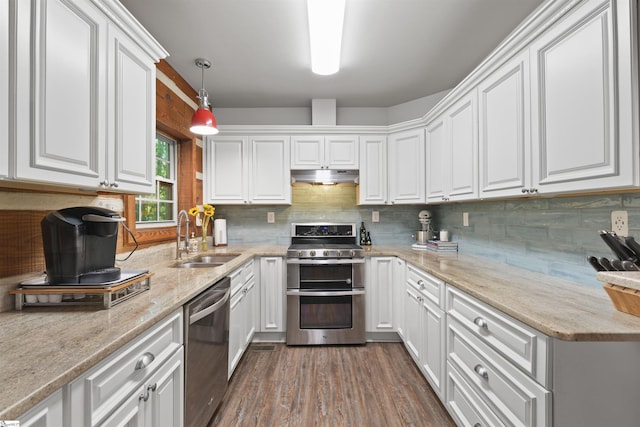 kitchen featuring white cabinetry, sink, hanging light fixtures, stainless steel appliances, and dark hardwood / wood-style flooring