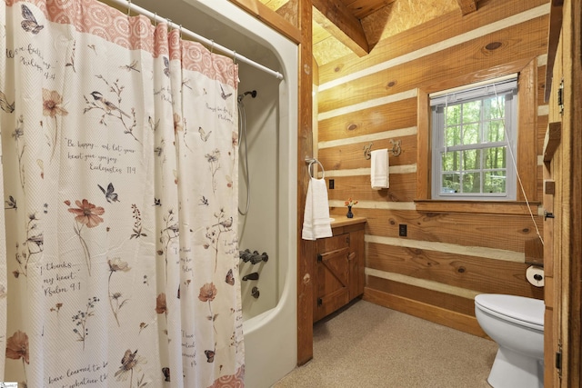 full bathroom with vanity, toilet, wooden walls, and shower / tub combo with curtain