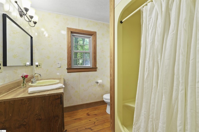 full bathroom featuring toilet, vanity, shower / tub combo with curtain, and hardwood / wood-style flooring