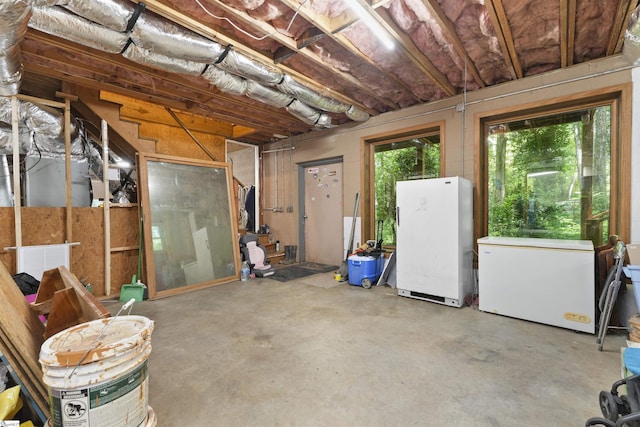 basement featuring refrigerator and white fridge