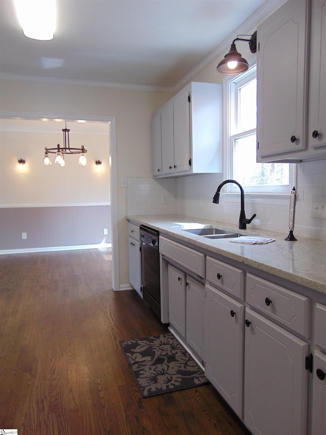 kitchen featuring white cabinets, pendant lighting, ornamental molding, and black dishwasher