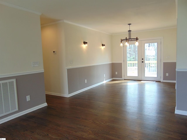 unfurnished room featuring crown molding, french doors, a chandelier, and dark hardwood / wood-style floors