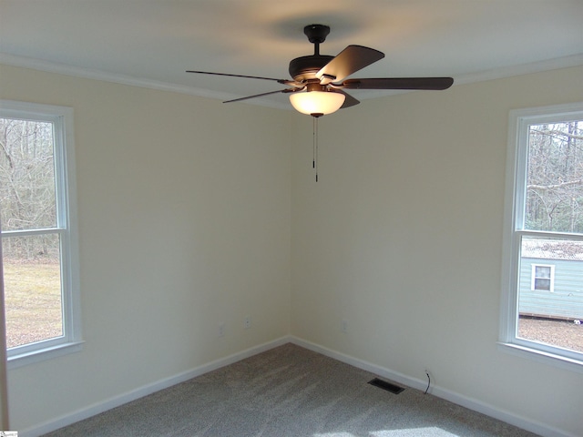 carpeted empty room with ceiling fan and crown molding