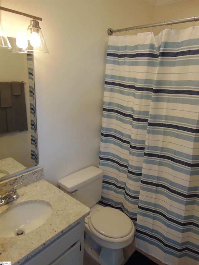 bathroom with vanity, toilet, and curtained shower