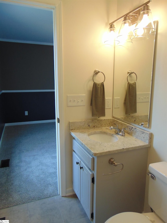 bathroom with tile patterned floors, vanity, and toilet