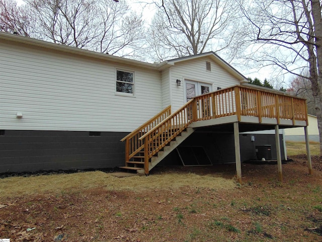 back of property with a wooden deck, french doors, and central AC unit