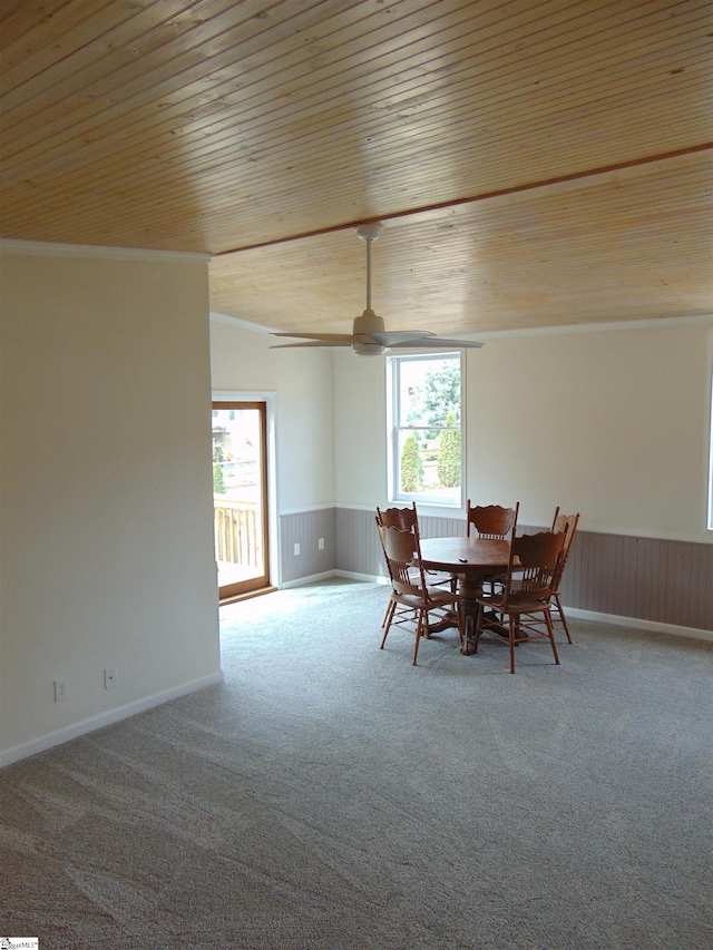 carpeted dining room featuring ornamental molding and wood ceiling