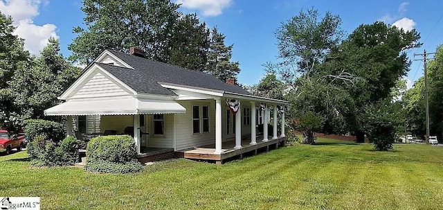 rear view of house with a yard