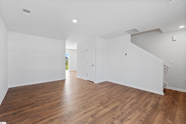 unfurnished living room with dark wood-type flooring