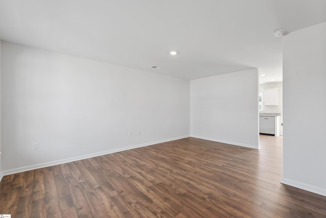 spare room with dark hardwood / wood-style floors