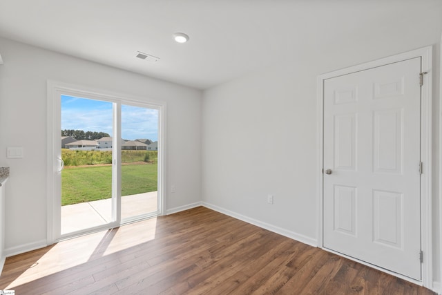 spare room featuring dark hardwood / wood-style floors