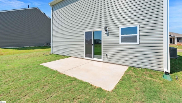 rear view of house with central AC unit, a yard, and a patio