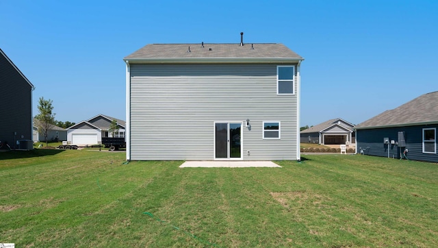 back of property with a lawn and a patio area