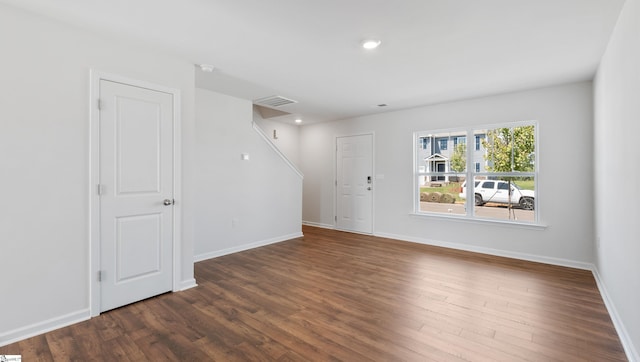 spare room with dark hardwood / wood-style floors