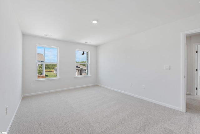 unfurnished room with light carpet