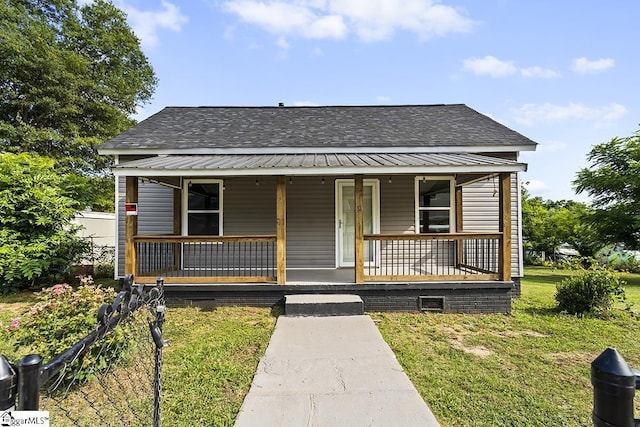 bungalow-style home with covered porch and a front lawn