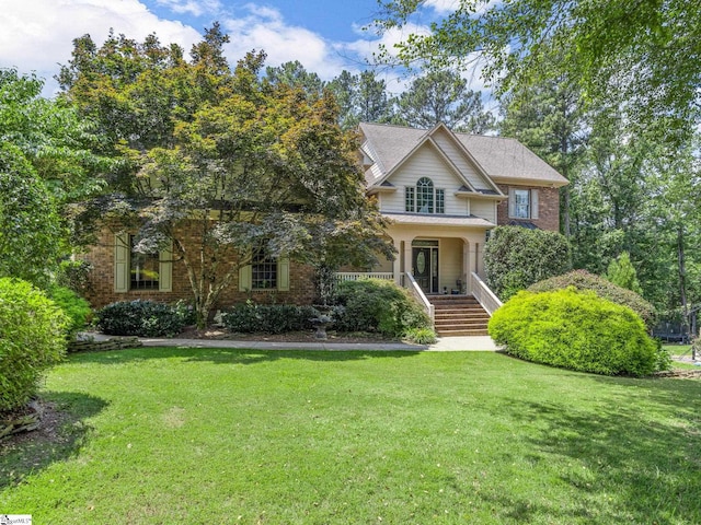 view of front of home with covered porch and a front yard