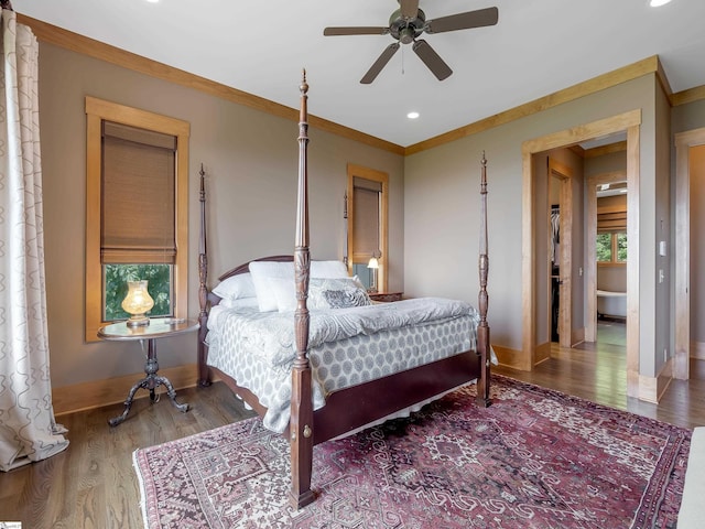 bedroom featuring multiple windows, ceiling fan, wood-type flooring, and ornamental molding