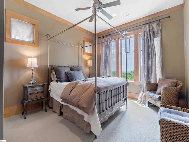 carpeted bedroom with ceiling fan and crown molding