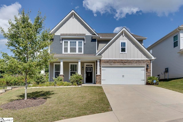 craftsman inspired home featuring covered porch, a garage, and a front lawn