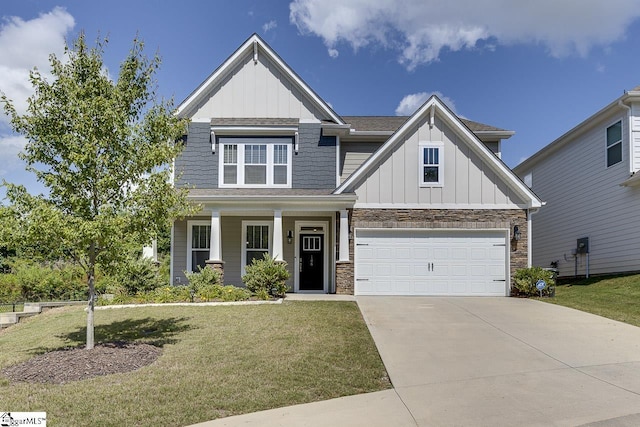 craftsman inspired home featuring a garage and a front lawn